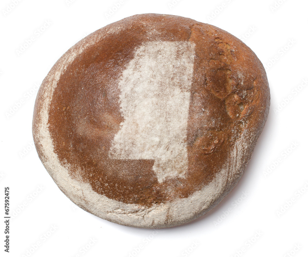 A loaf of fresh bread covered with rye flour in the shape of Mis A loaf of fresh bread covered with rye flour in the shape of Mis