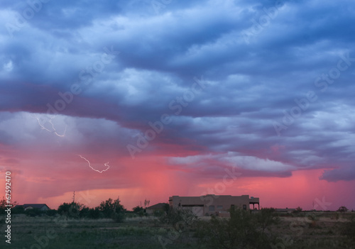 A Dance of Lightning and Sunset Above a Neighborhood