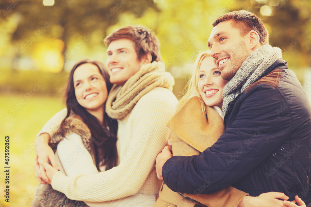 Fototapeta premium group of friends having fun in autumn park