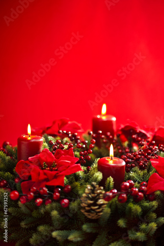 Advent wreath over red background