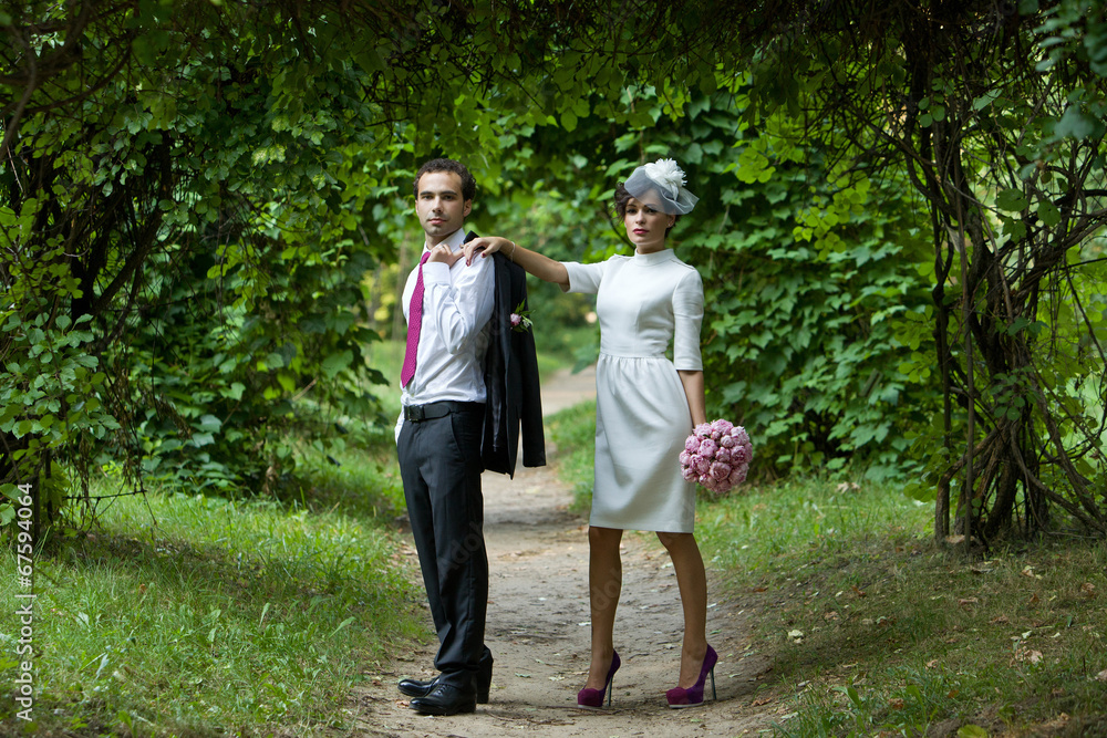 Fototapeta premium Wedding. Bride and groom in the garden on a summer evening.