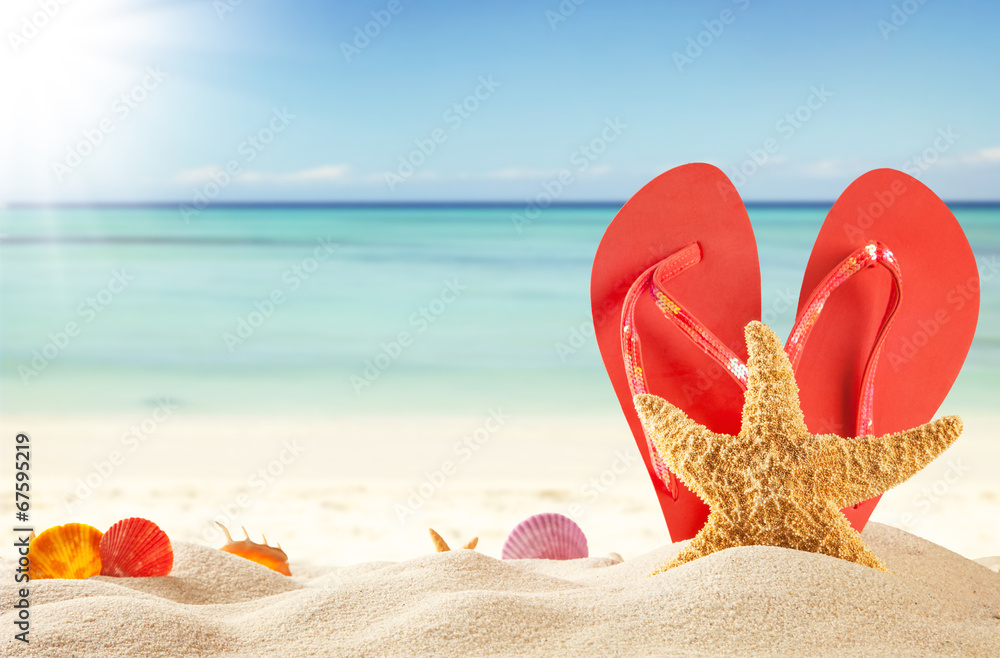 Summer beach with red sandals and shells Summer beach with red sandals and shells