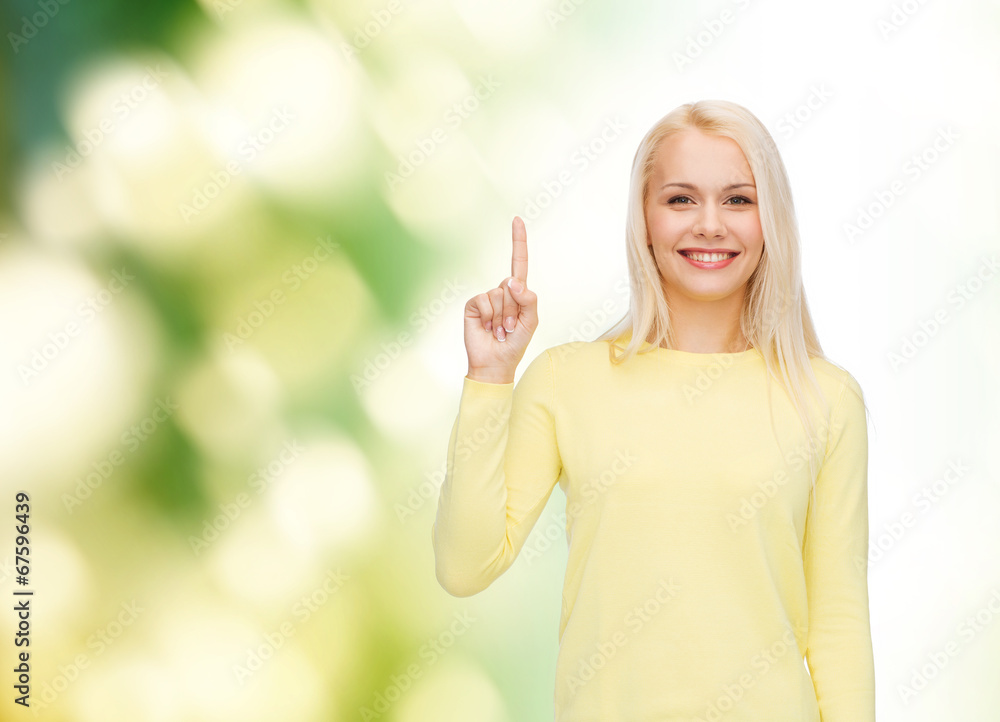 smiling woman pointing her finger up smiling woman pointing her finger up
