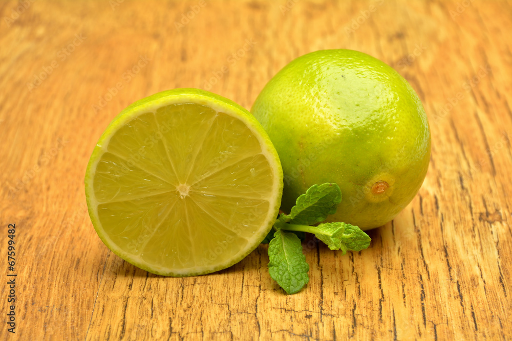 Fresh green lime on old wooden background Fresh green lime on old wooden background
