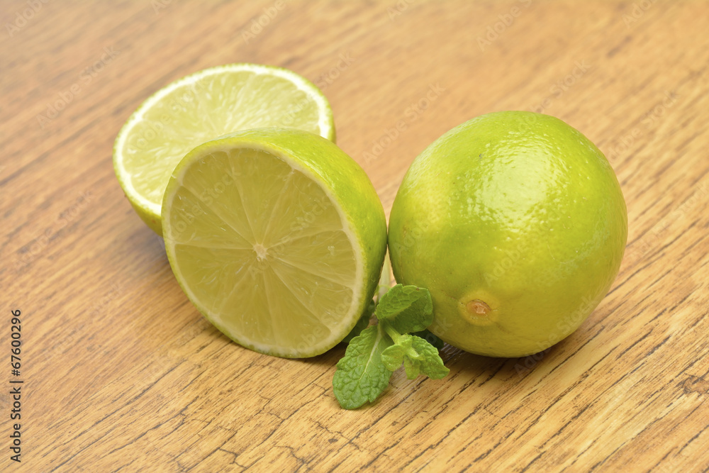 Fresh green lime on old wooden background Fresh green lime on old wooden background
