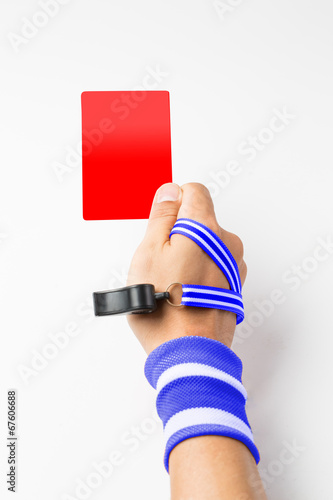 Referee hand and whistle show card to player photo