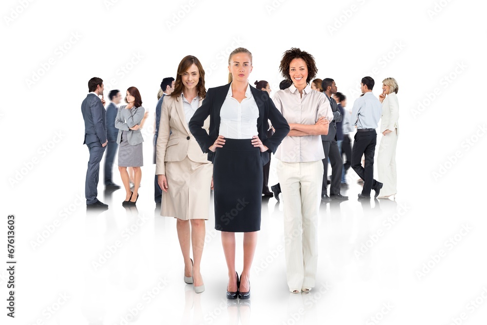 Composite image of team of businesswomen looking at camera Composite image of team of businesswomen looking at camera