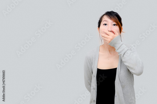 Chinese Asian woman Model wearing grey cardigan and close her mo