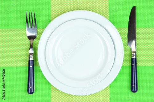 Knife  color plate and fork  on color background