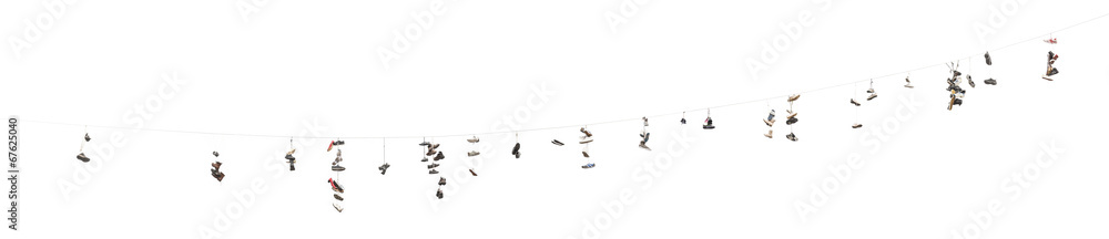 Old worn boots or shoes hang on a cable Old worn boots or shoes hang on a cable