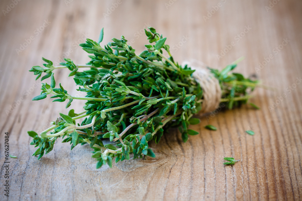 bunch of fresh thyme on a wooden background bunch of fresh thyme on a wooden background