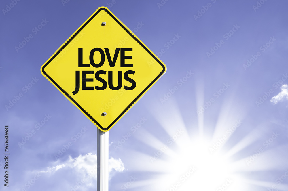 Love Jesus road sign with sun background