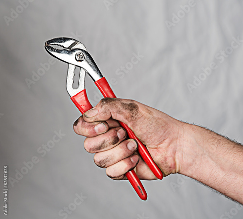 hand with a pipe wrench photo