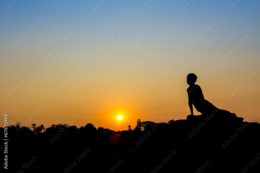 Silhouette of a man in Yoga posting
