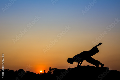 Fototapeta Naklejka Na Ścianę i Meble -  Silhouette of a man in Yoga posting