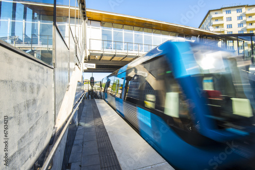 Train arrives at Skarmarbrink metro station, Stockholm (Sweden) photo