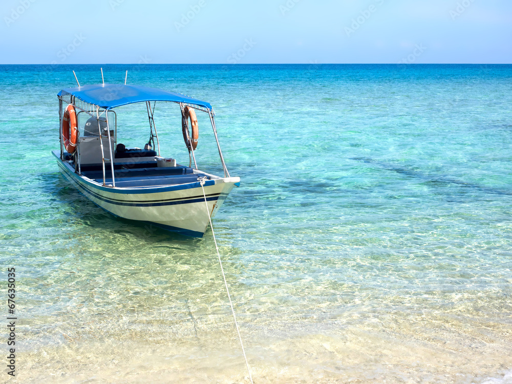 Boat Floating on Turquoise Colored Water