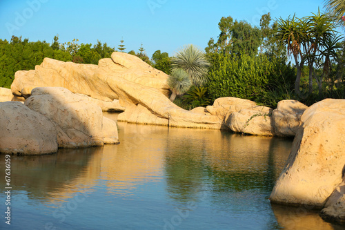 Natural landscaping. Lake with stones