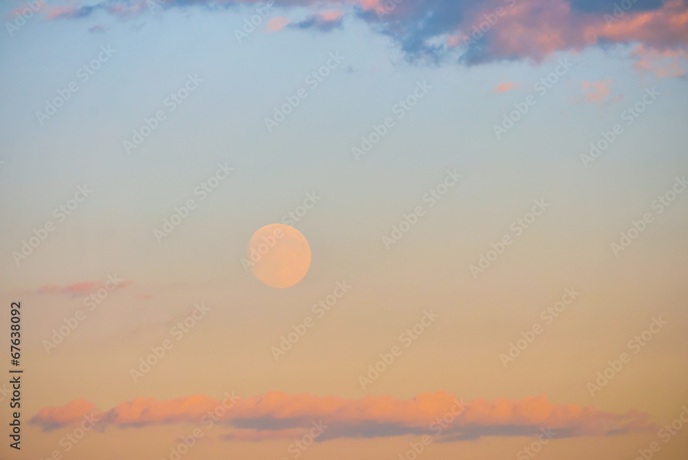 Sunset with colorful moon and clouds