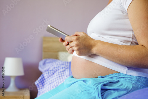 Pregnant woman with tablet