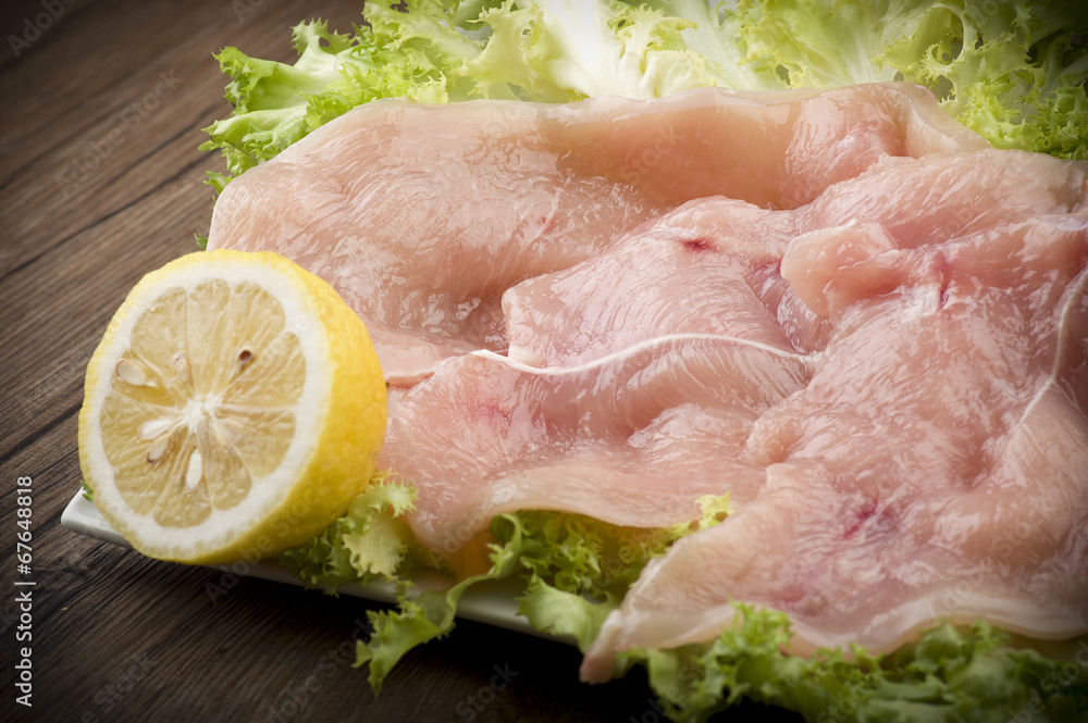slices of chicken with salad on wood slices of chicken with salad on wood