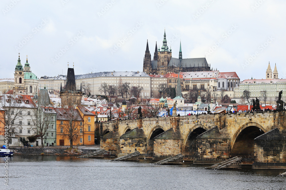 Snowy gothic Prague Castle with the Charles Bridge