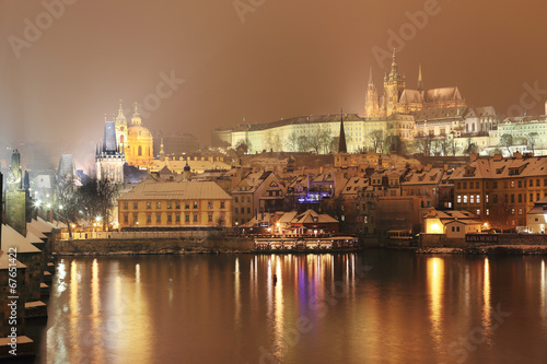 Night snowy Prague City with gothic Castle  Czech republic