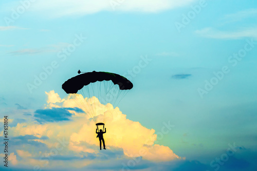 unidentified skydiver, parachutist on blue sky