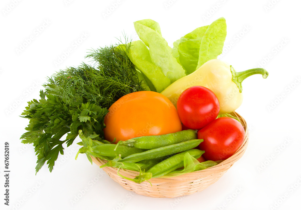 Fresh vegetables in the basket isolated over white Fresh vegetables in the basket isolated over white