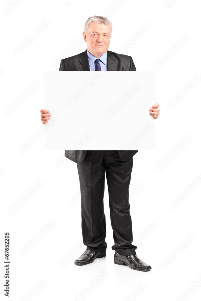 Mature businessman holding a blank poster Mature businessman holding a blank poster