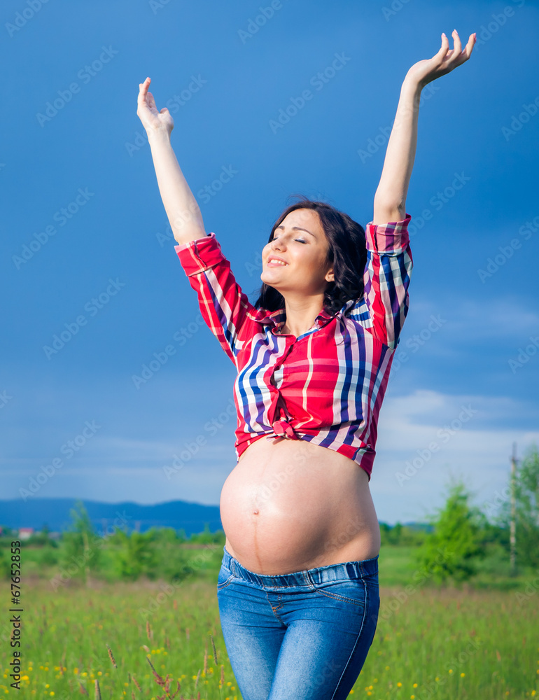 Beautiful pregnant woman relaxing outside Beautiful pregnant woman relaxing outside