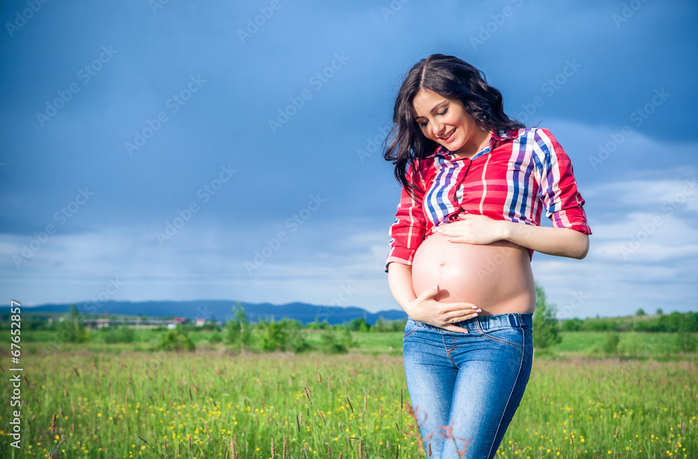 Fototapeta premium Beautiful pregnant woman relaxing outside