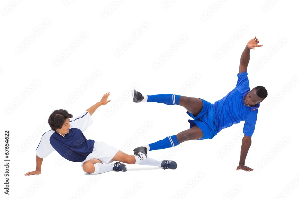Football players tackling for the ball Football players tackling for the ball
