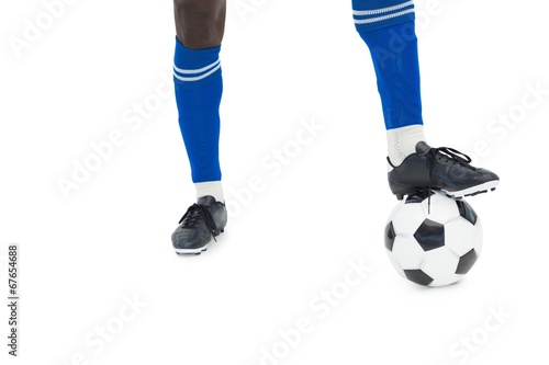 Football player in blue with ball