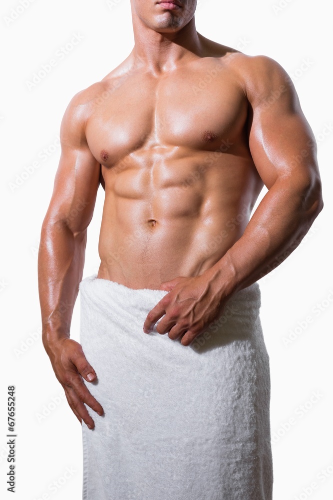 Mid section of a shirtless muscular man in white towel