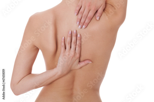 Woman caressing her bare shoulder and back