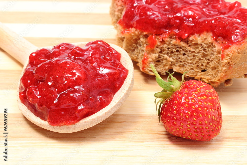 Fresh fruits and strawberry jam on wooden cutting board Fresh fruits and strawberry jam on wooden cutting board