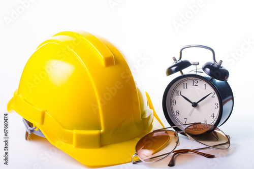 Safety helmet isolated with alram clock photo