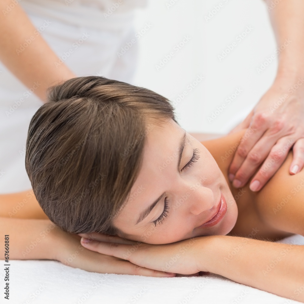 Attractive woman receiving shoulder massage at spa center Attractive woman receiving shoulder massage at spa center