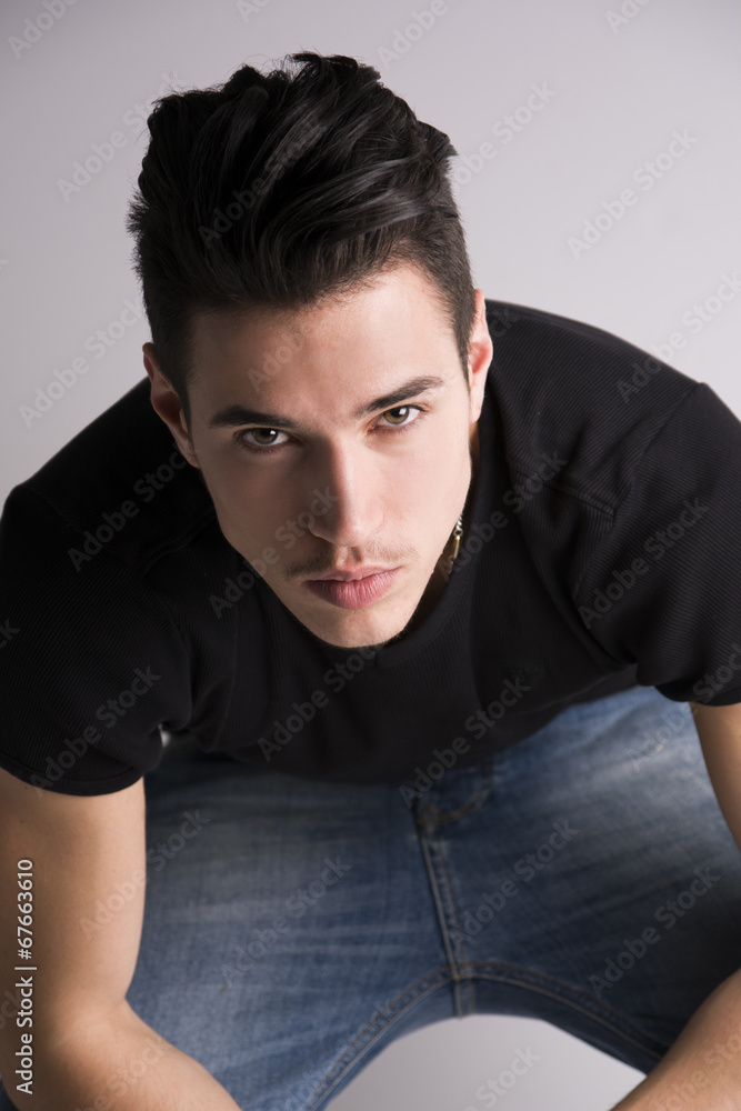 Fototapeta premium Handsome young man sitting, seen from above