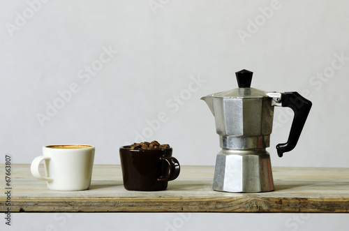 two cups of coffee and beans and percolator photo