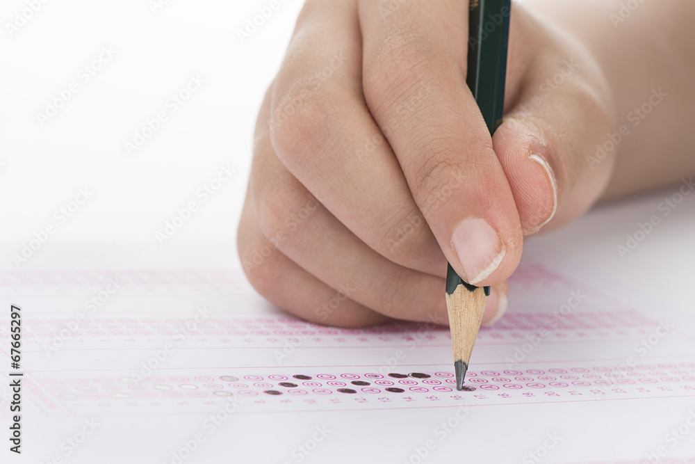 Filling answers of multiple choice examination close up Filling answers of multiple choice examination close up