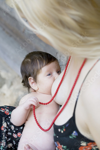 close up portrait of baby breastfeeding