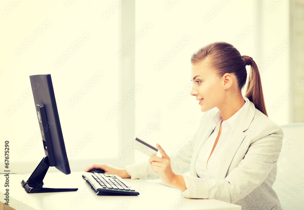 businesswoman with computer using credit card businesswoman with computer using credit card