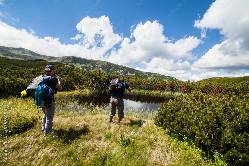 Hikers nearby a lake in the mountains