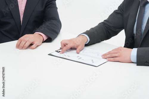 Two business people in elegant suits, chief and employee, holdin