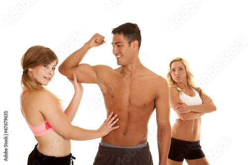 fitness man with two women one mad arms folded