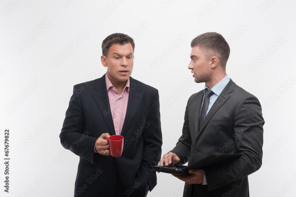 Senior and junior business people discuss something during their Senior and junior business people discuss something during their