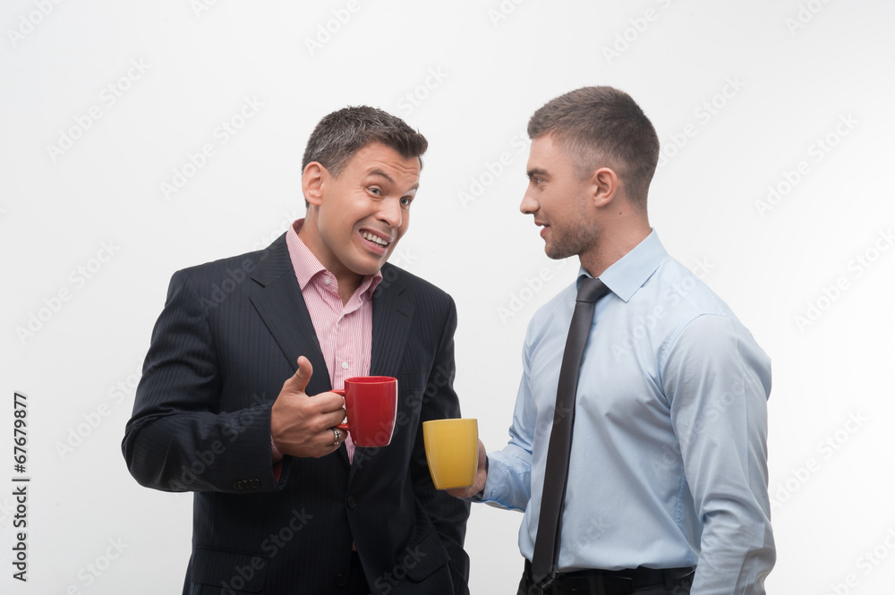 Senior and junior business people discuss something during coffe Senior and junior business people discuss something during coffe