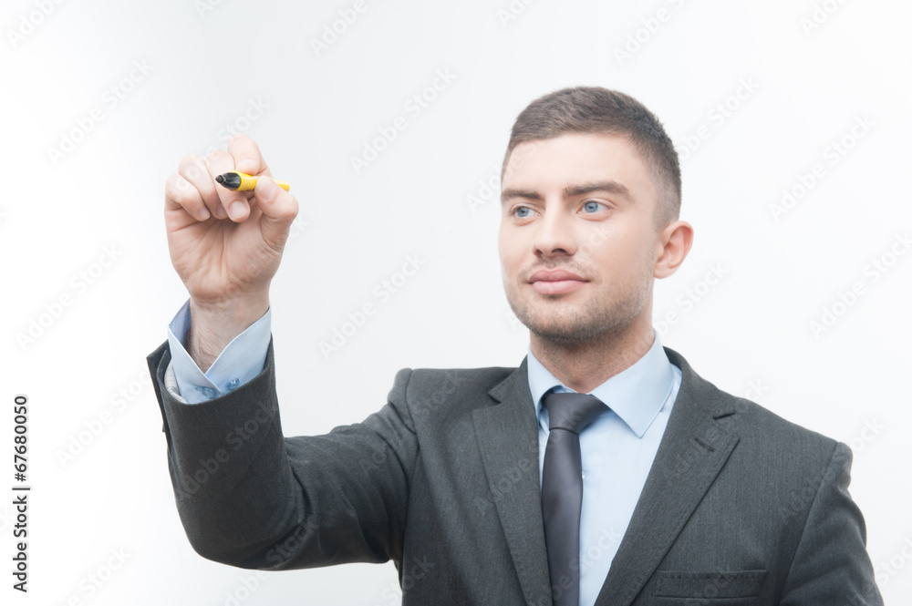 Closeup portrait of young handsome businessman in suit writing s Closeup portrait of young handsome businessman in suit writing s
